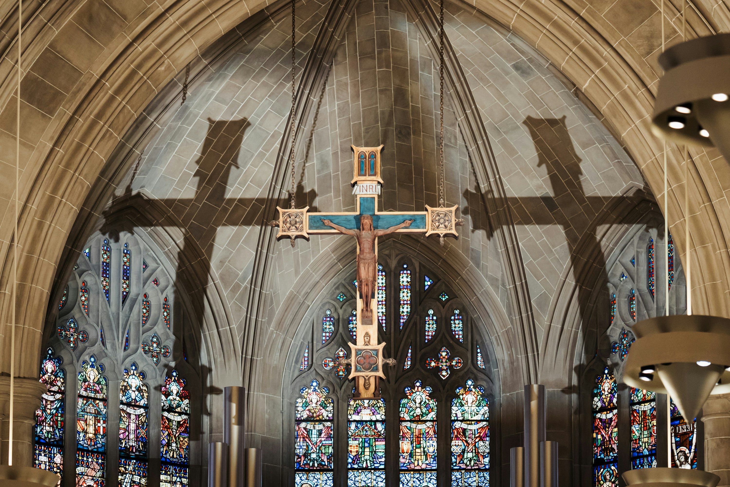A crucifix hangs in a church window.