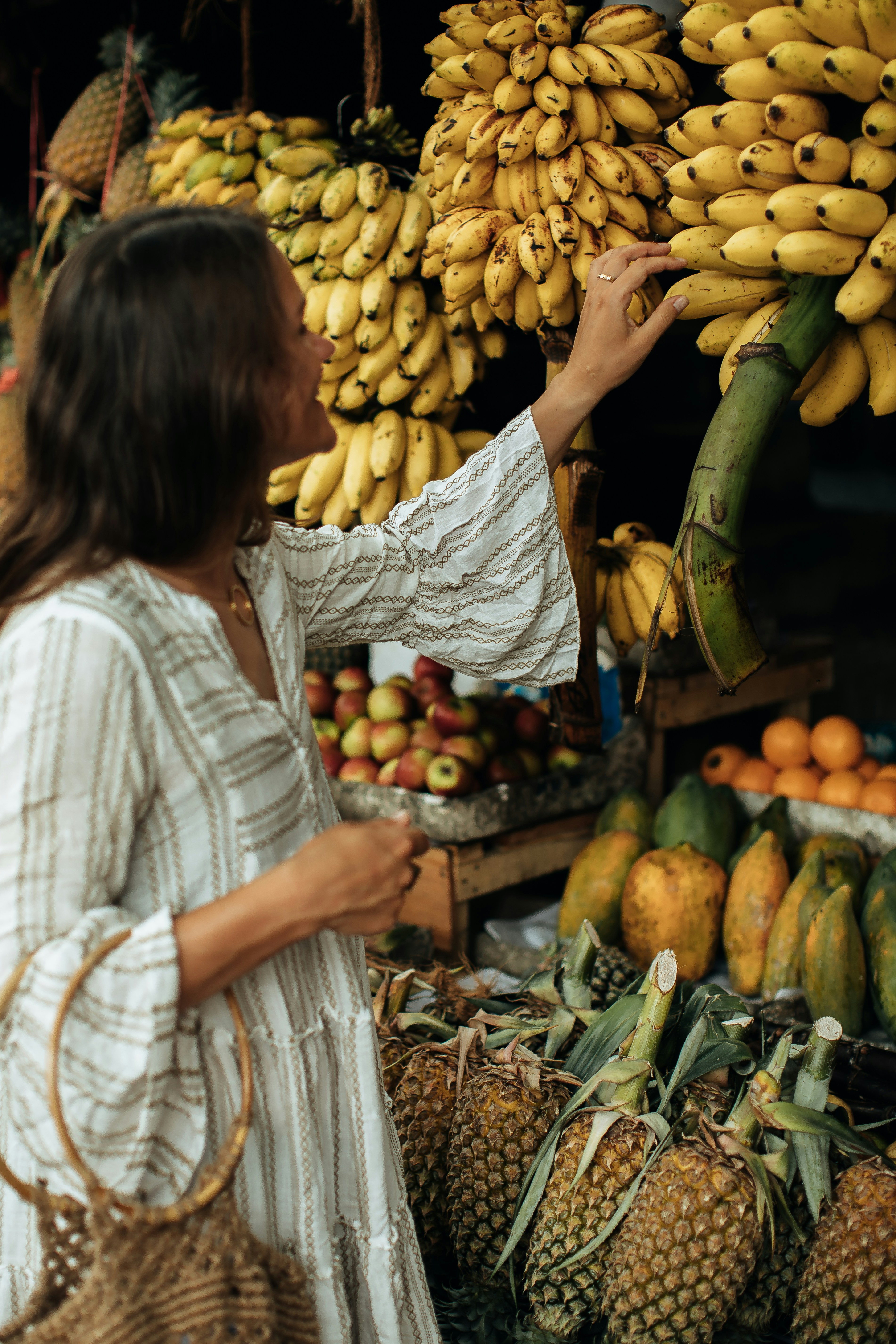 Mulher compra frutas em um mercado.