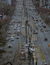Cars travel on a wide city street.