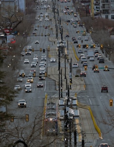 Cars travel on a wide city street.
