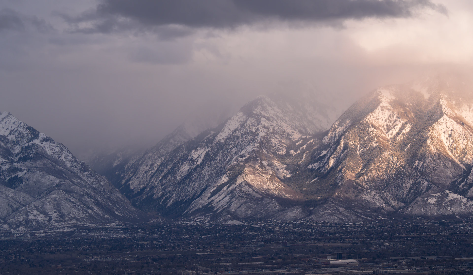 Snow-capped mountains shrouded in atmospheric mist.