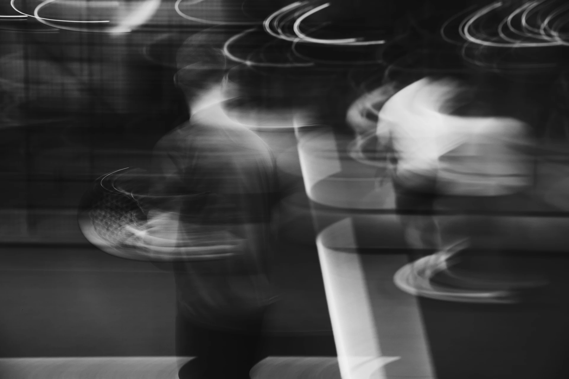 Blurred figures are walking, captured in motion.