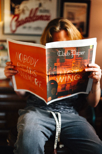 A person is reading a newspaper.