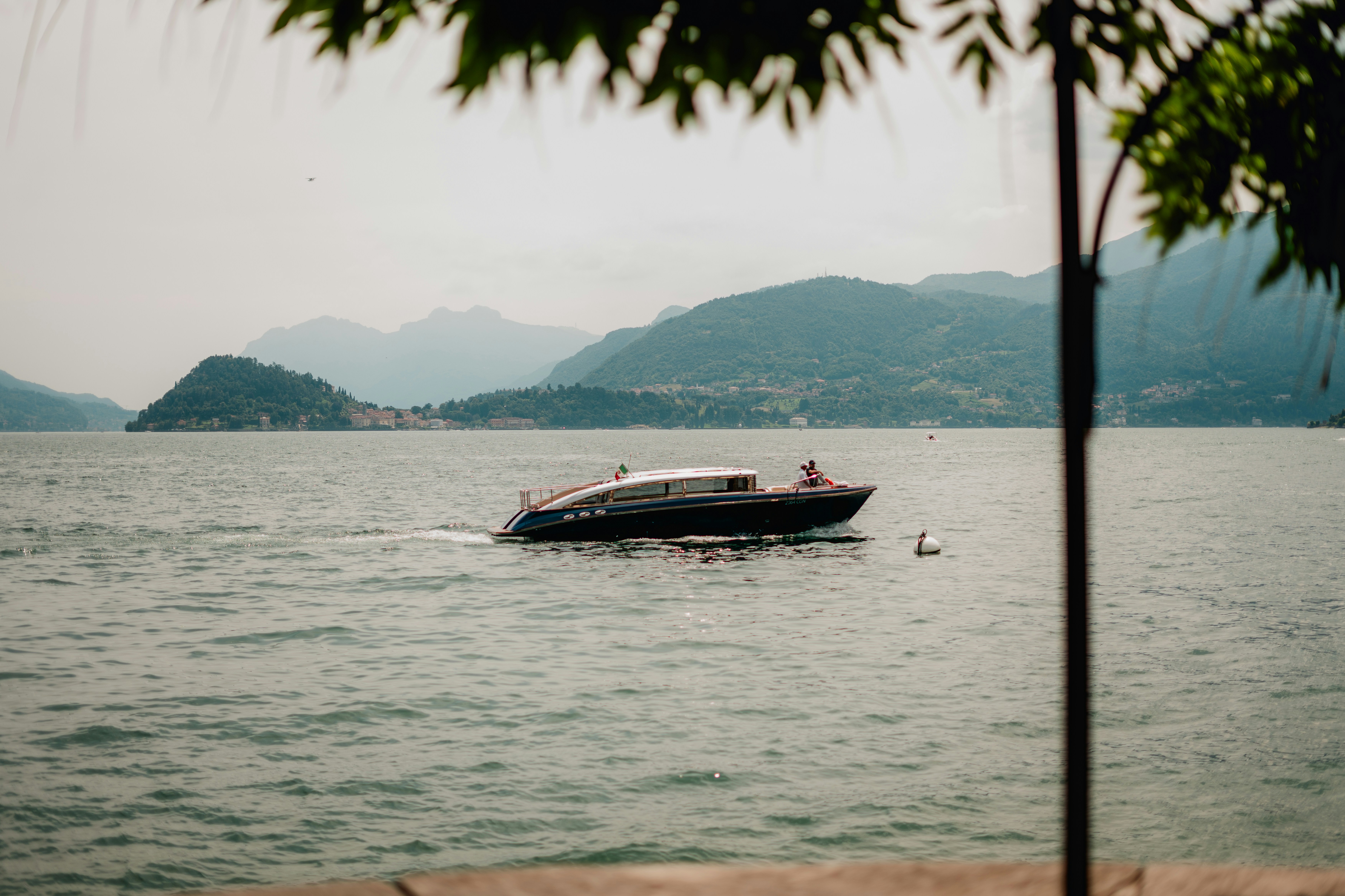 A boat travels across the calm water.