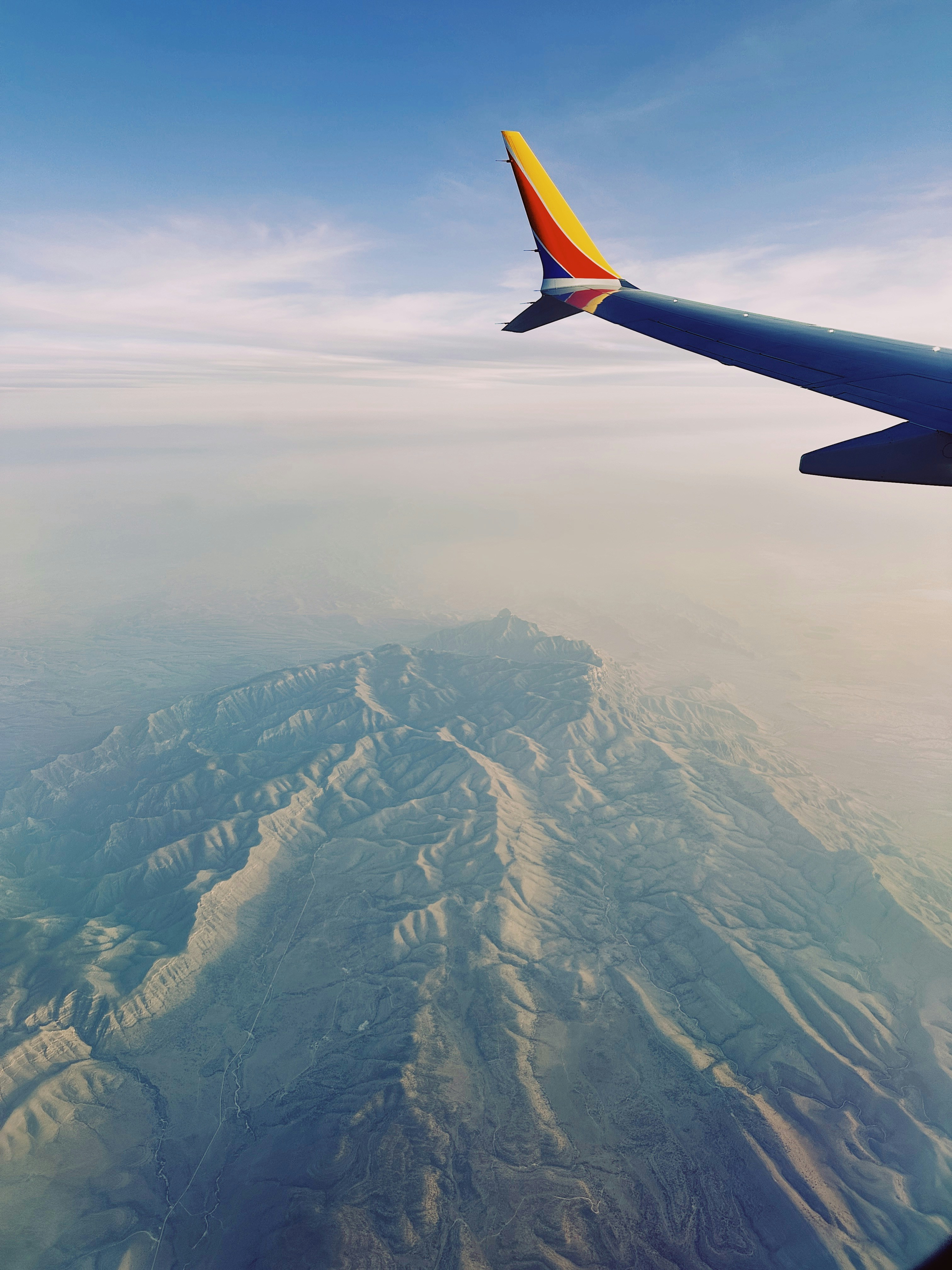 A southwest plane flies above mountains.
