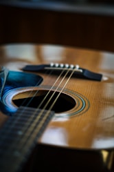 Acoustic guitar's sound hole and strings.