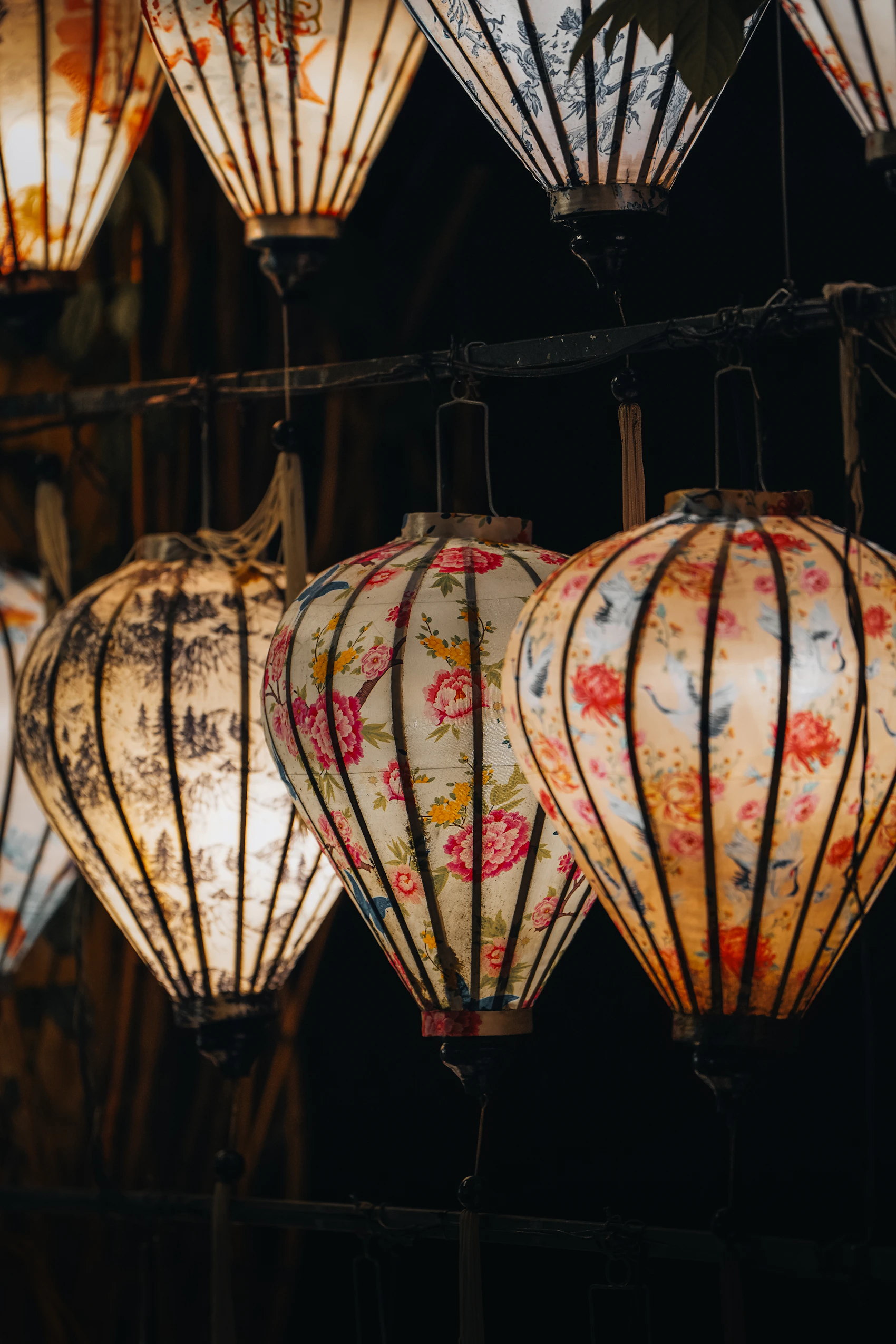 Patterned lanterns glowing at night in Hội An
