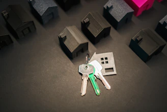 Keys representing a new home and many house models.