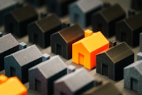 A single, bright house stands out from the rest.