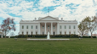 The white house stands under a bright sky.
