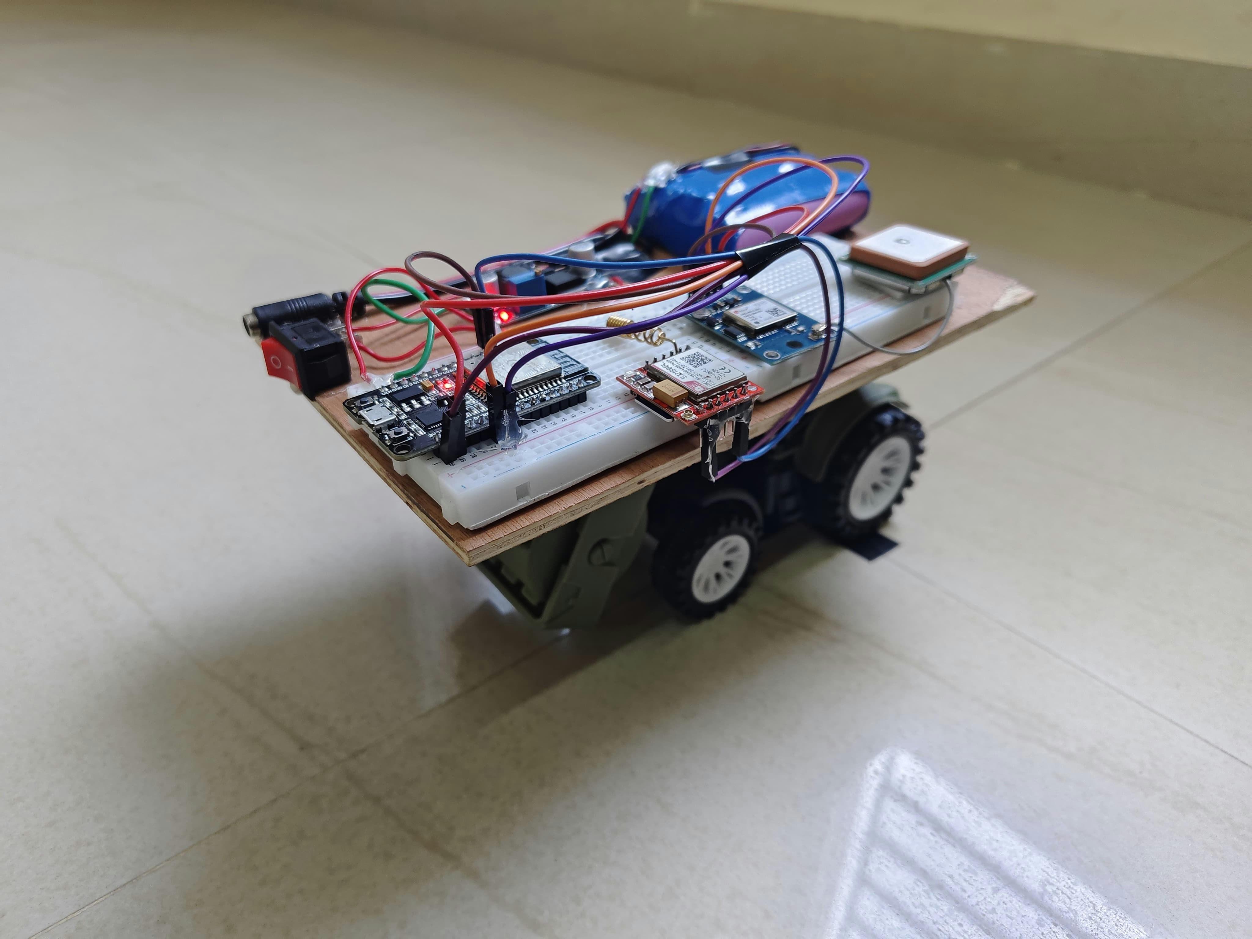 A custom-built robot sits on a light-colored floor.