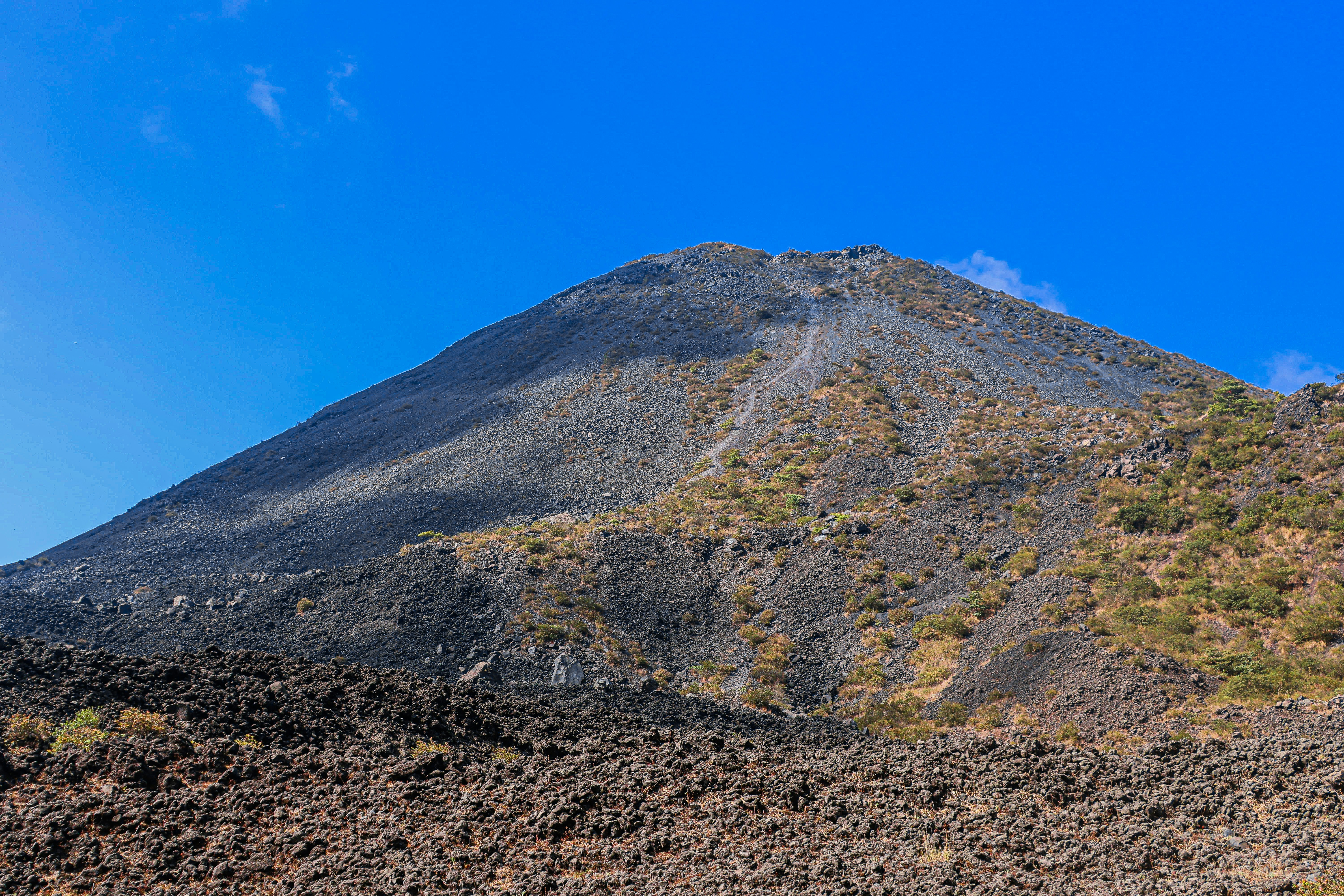 Volcano against a bright blue sky.