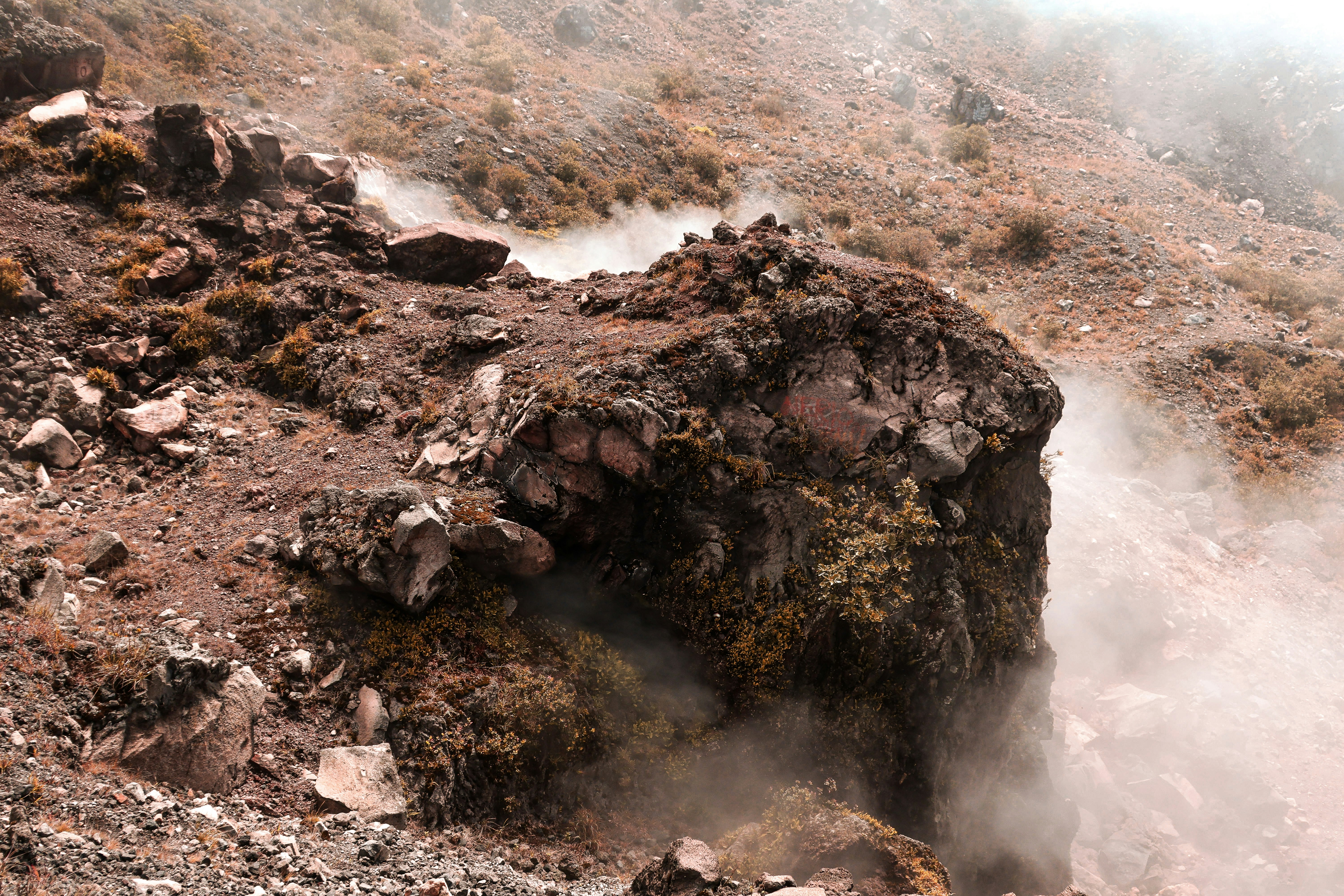 Rocky terrain and misty fog.