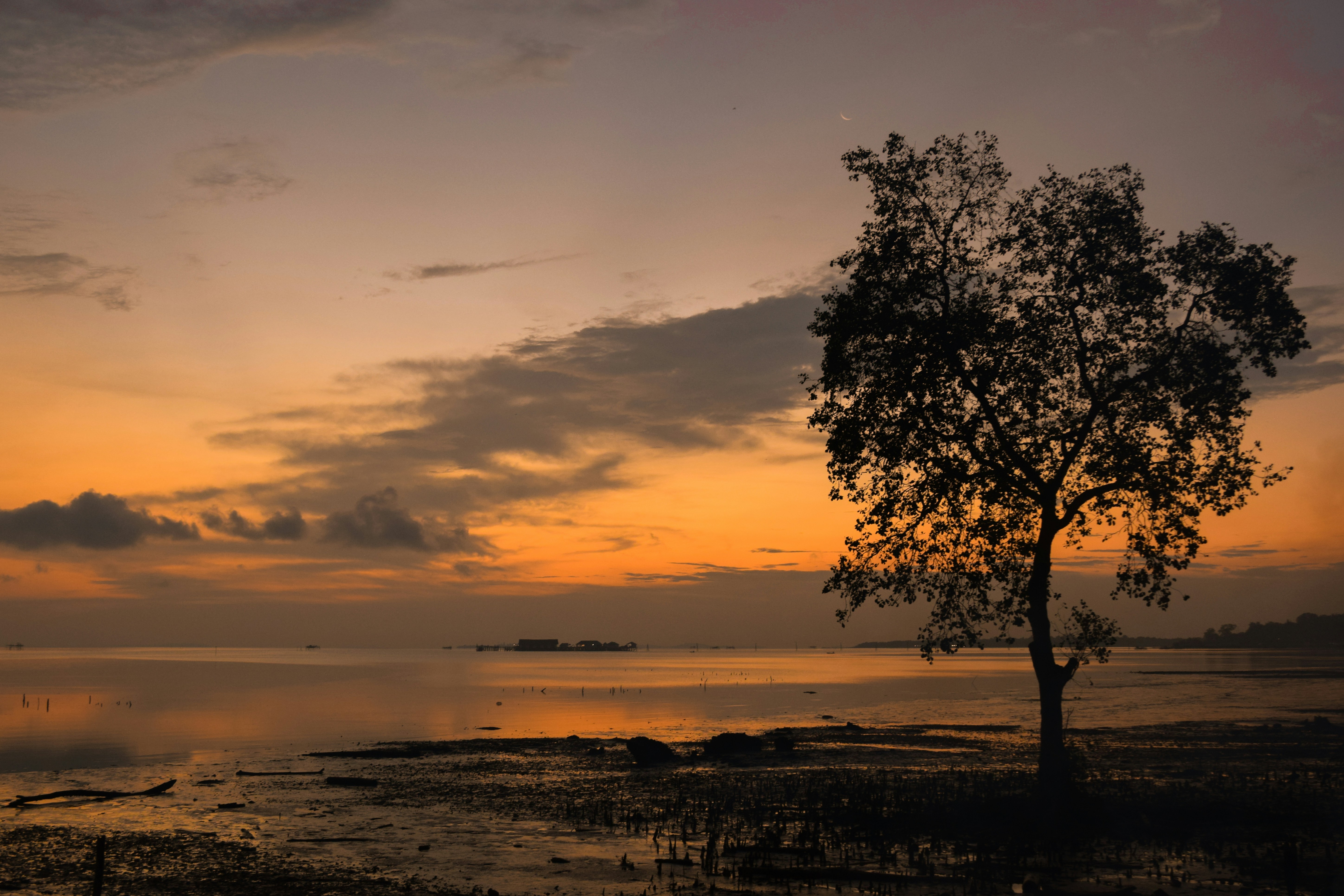 Sunrise casts an orange glow over the landscape.
