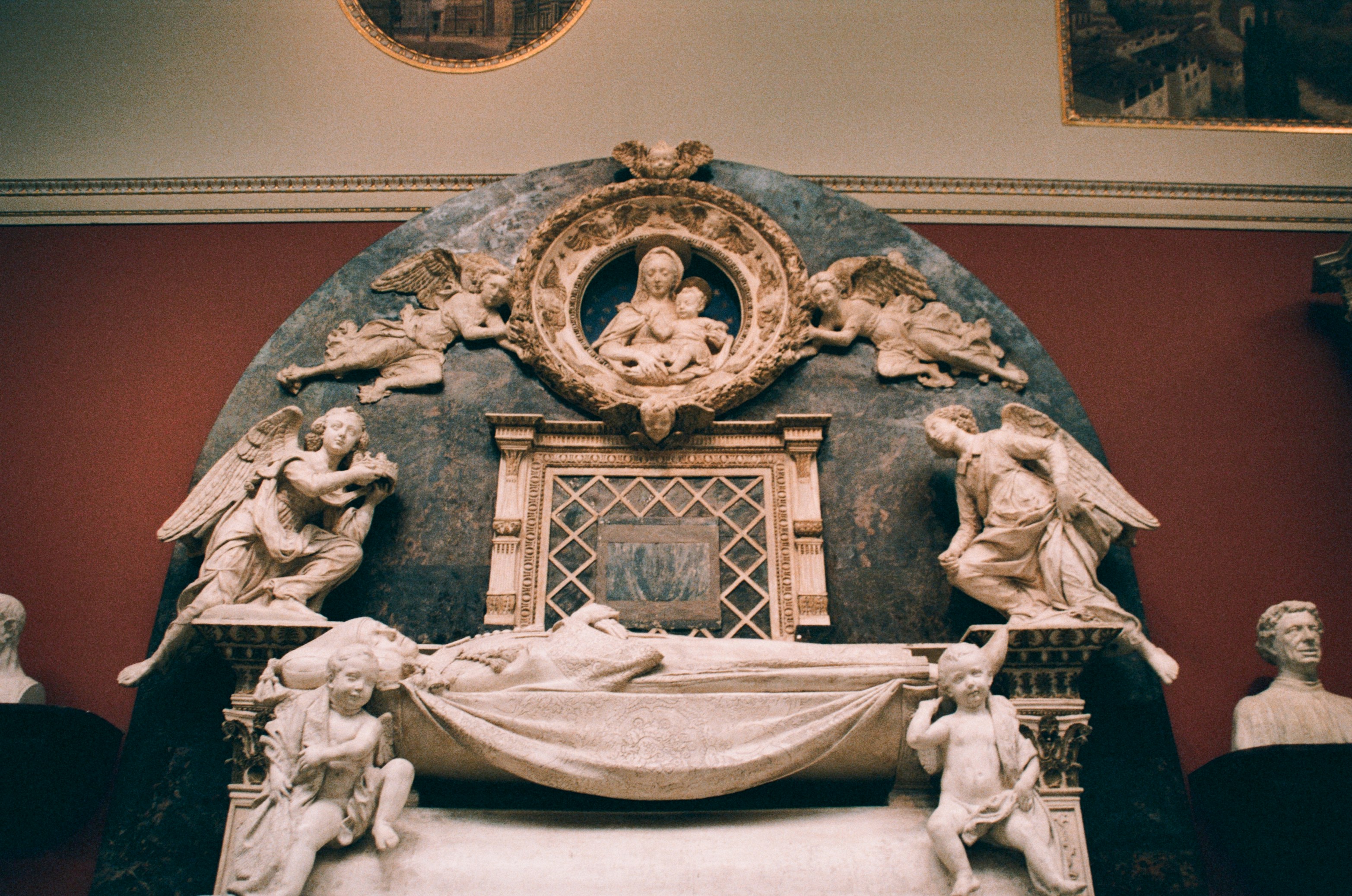 A marble sculpture shows madonna and child.