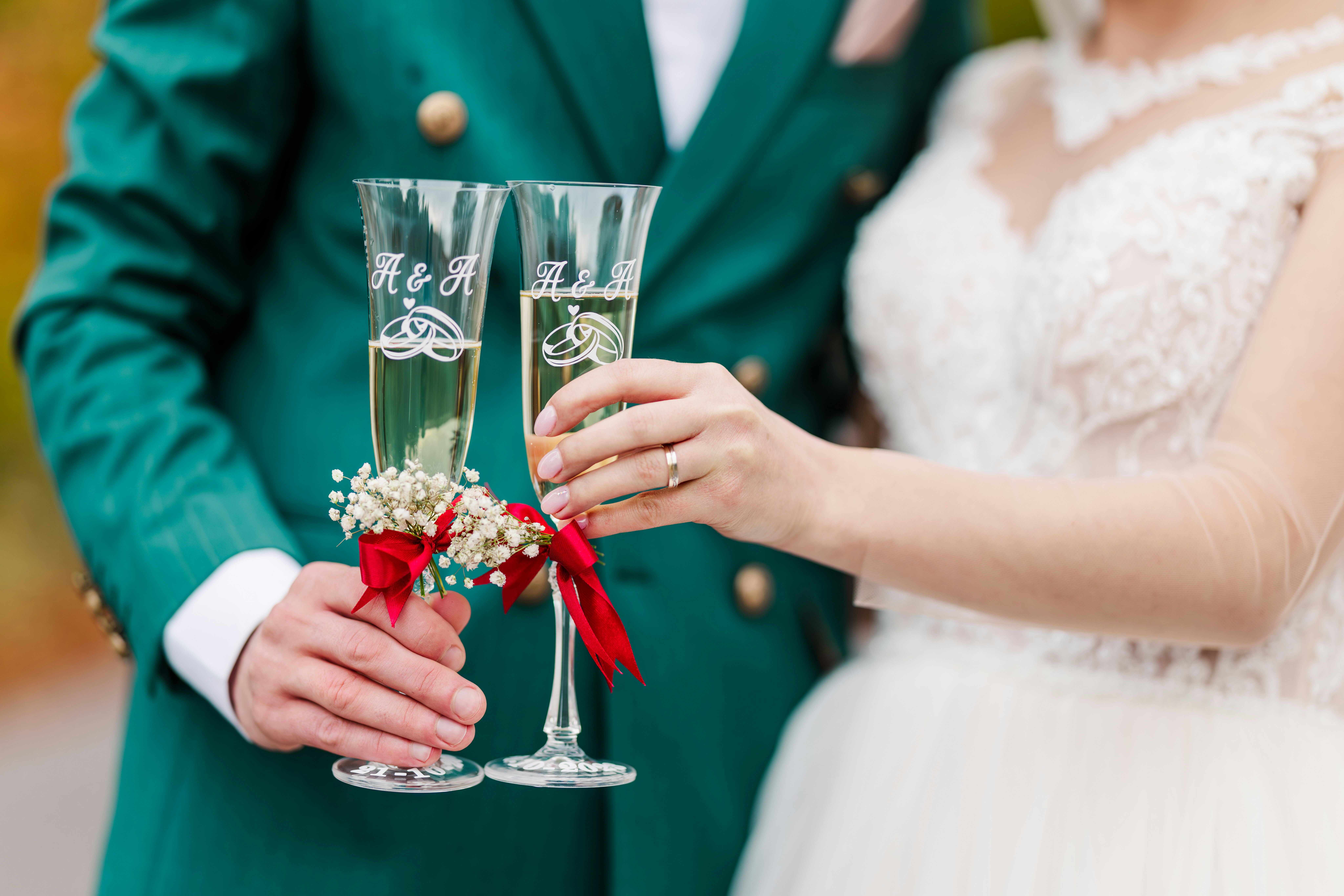 Newlywed couple toasting with engraved champagne flutes, representing anniversaries, weddings, engagements, housewarming gifts, and celebrating love. - special gifts for couples