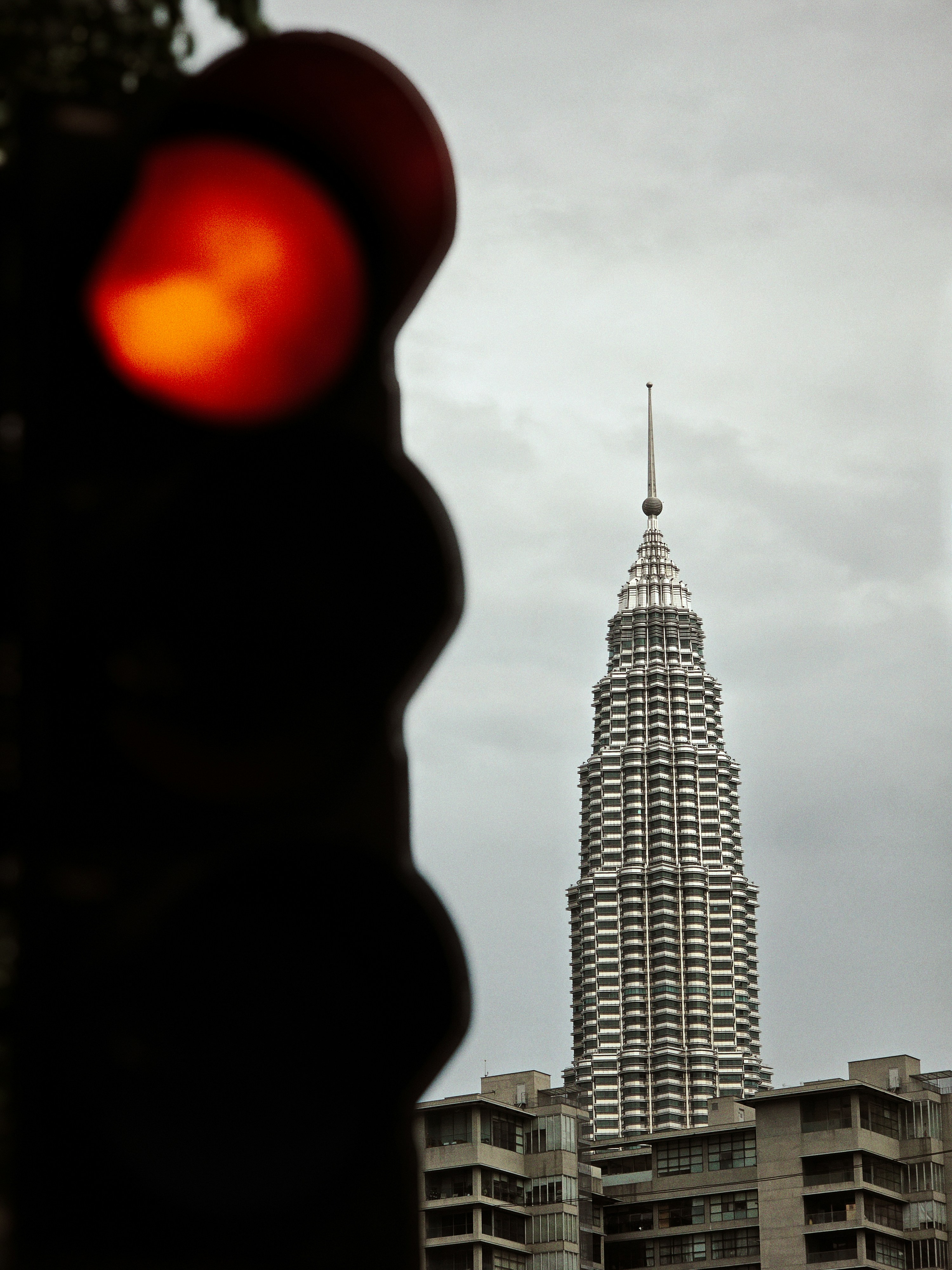 A red light frames the tall building.