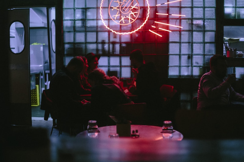 People gather inside a dimly lit establishment.