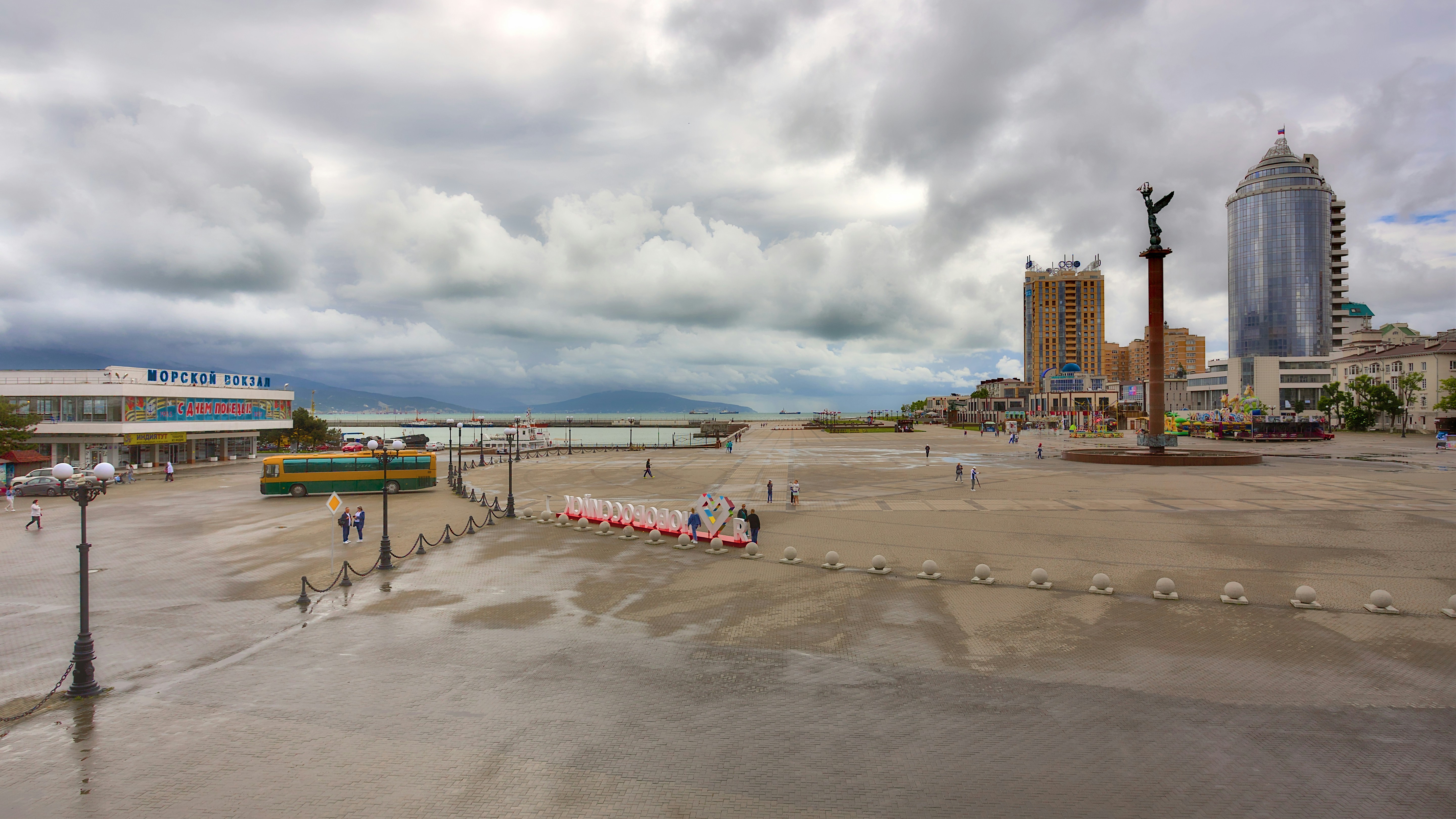 A wet promenade under a stormy sky.