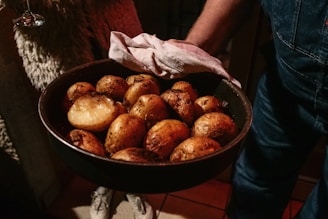 Roasted potatoes are served in a pan.
