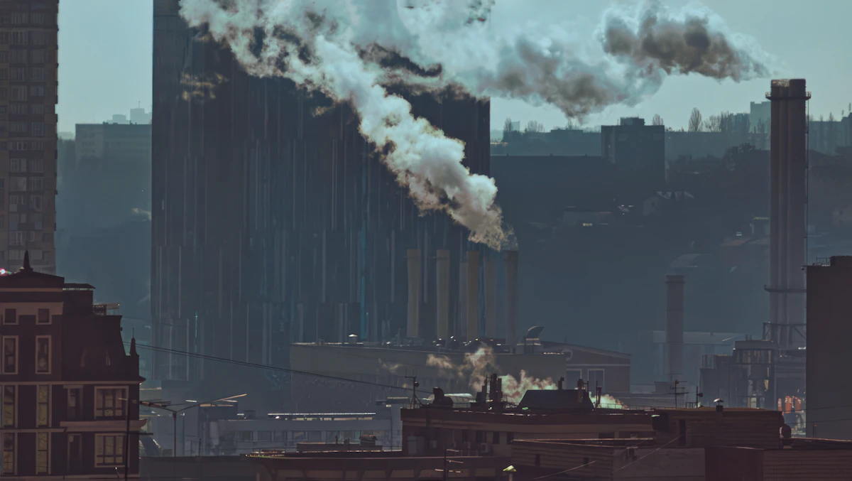 Industrial smoke over a city skyline highlighting air-quality risk for lung disease