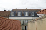 Buildings with tiled roofs and dormer windows.