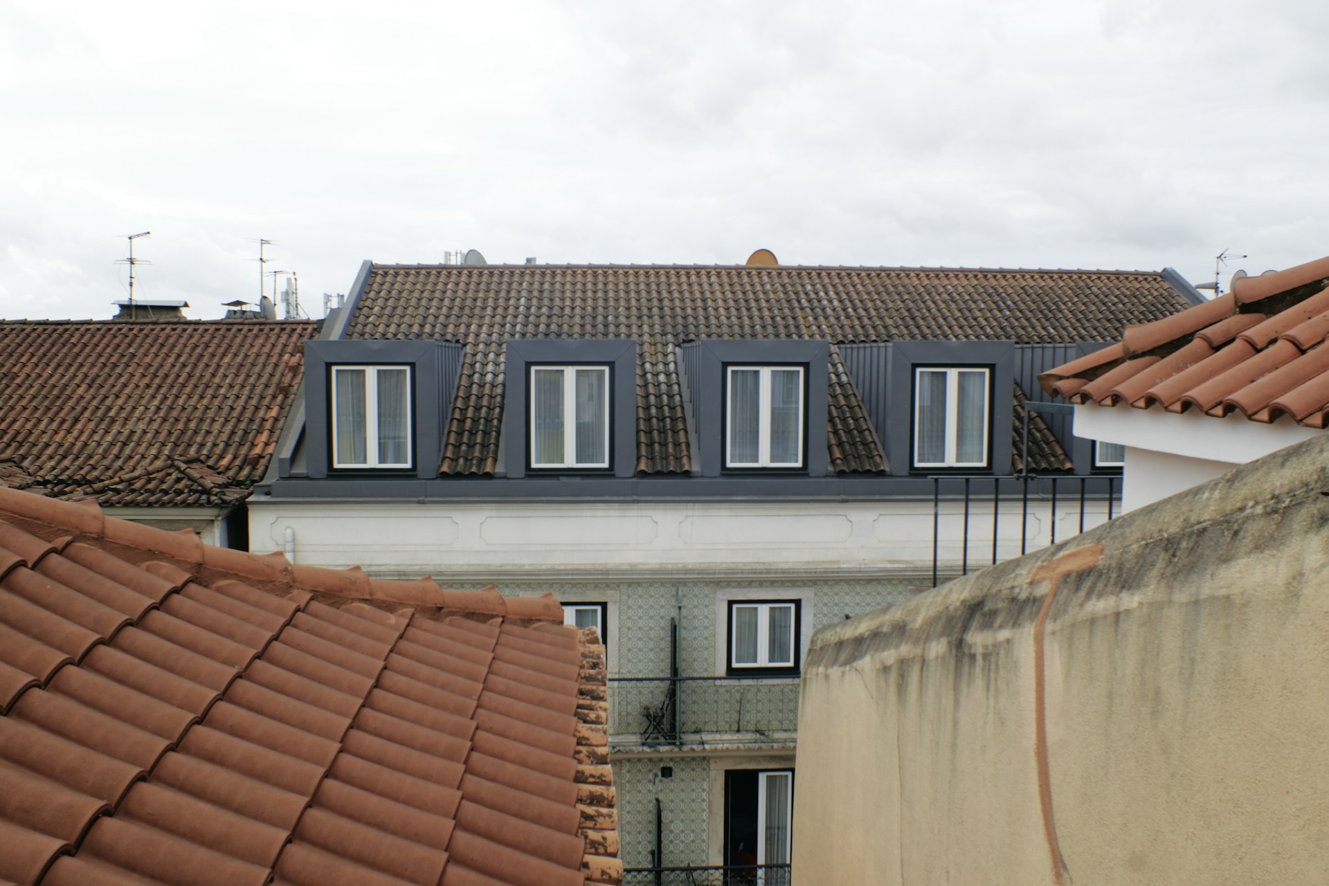 Buildings with tiled roofs and dormer windows.