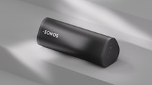 A sonos speaker sits angled on a surface.