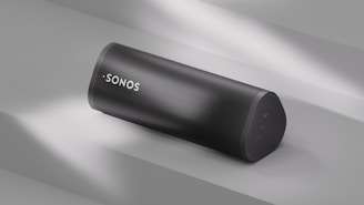 A sonos speaker sits angled on a surface.