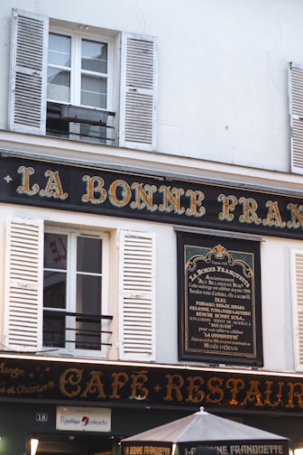 A cafe-restaurant sign in paris, france.