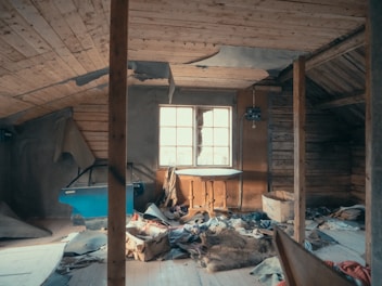 An attic with visible structural damage is shown.