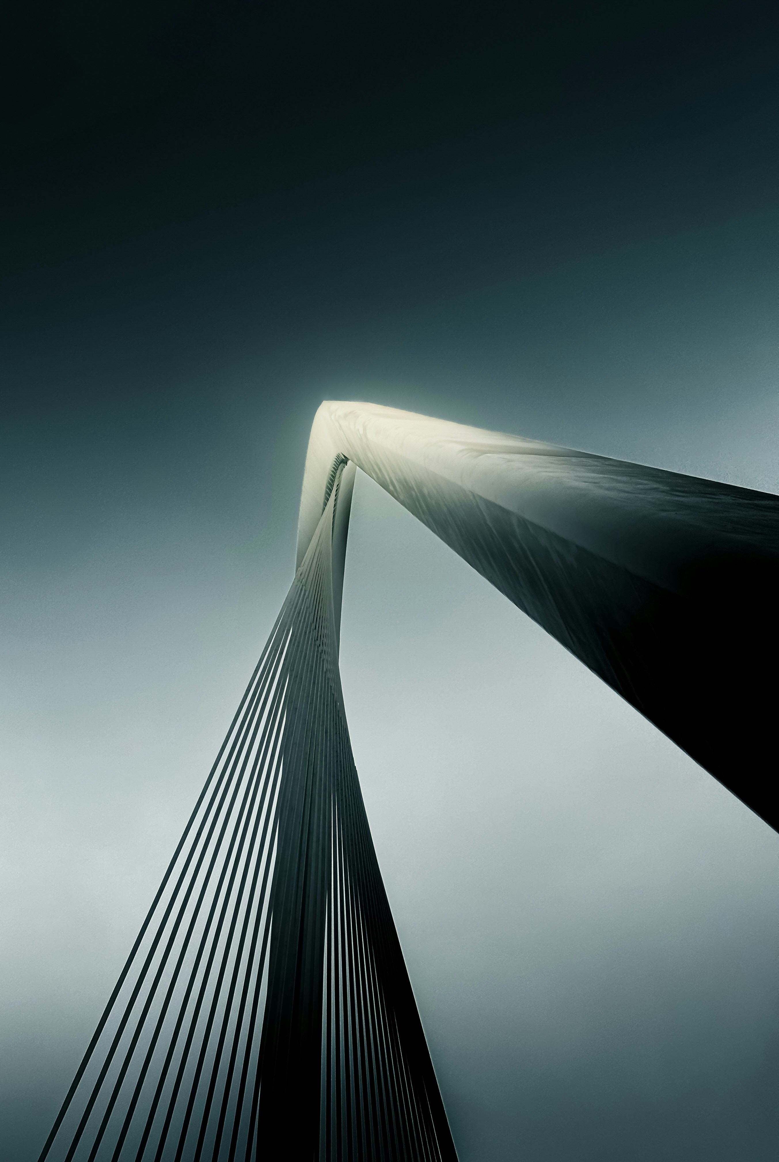 Bridge structure against a moody, overcast sky.