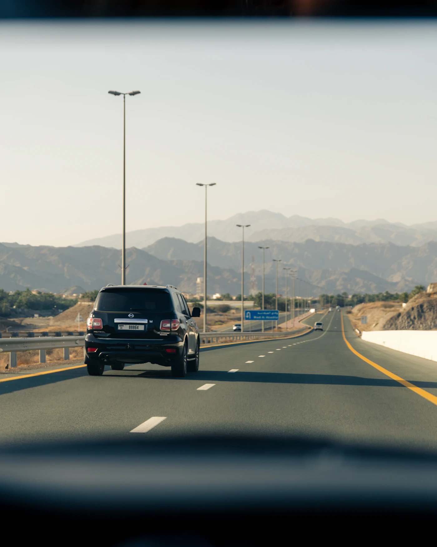 Car travelling on a scenic highway with mountain views