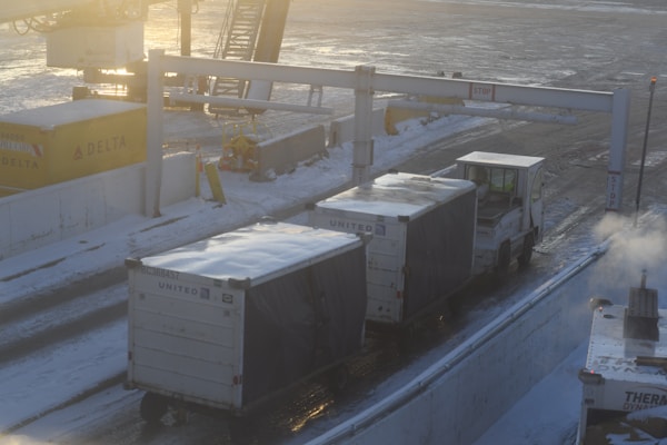 Trucks and trailers on a snow-covered cargo ship.