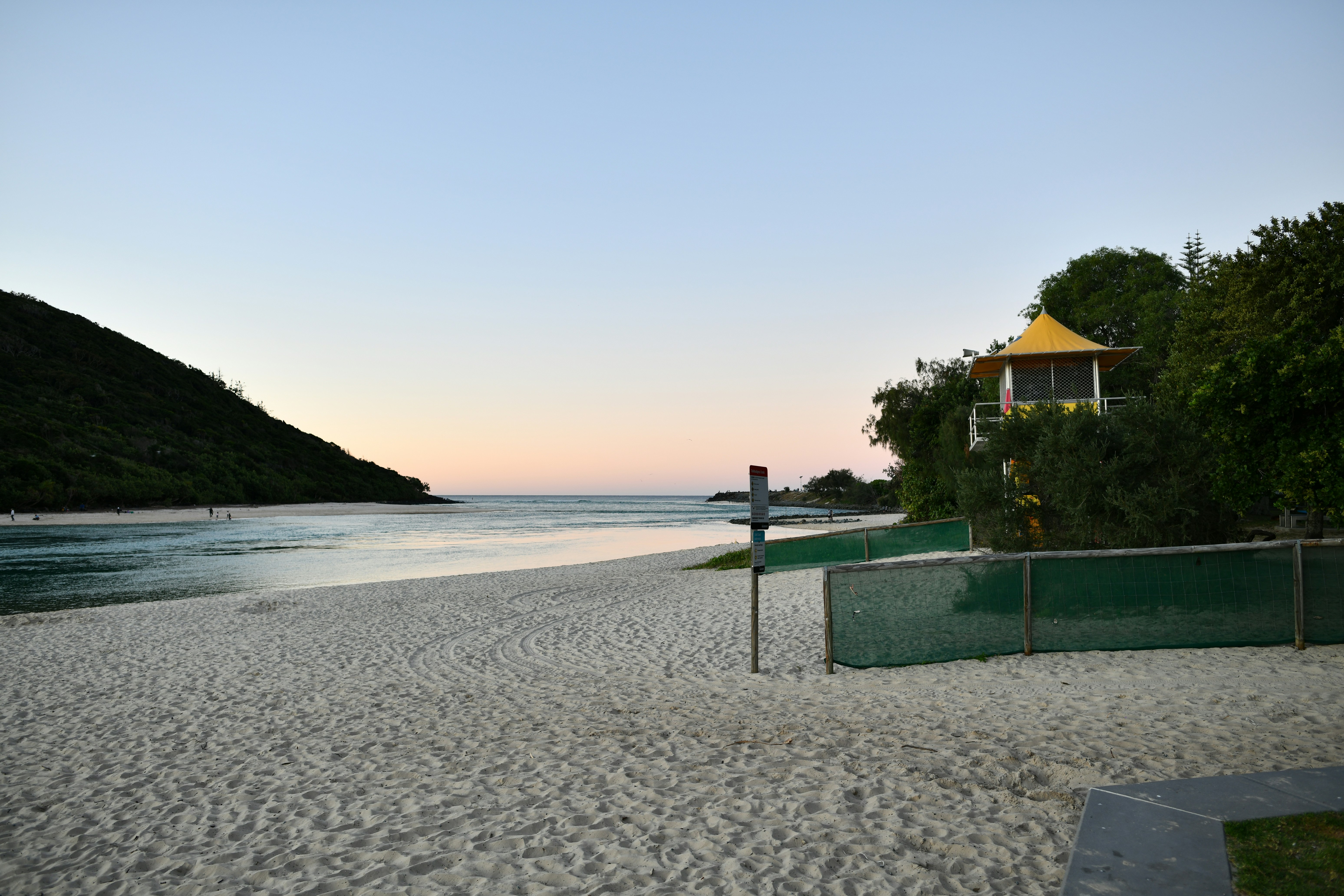 A serene beach scene at dusk.