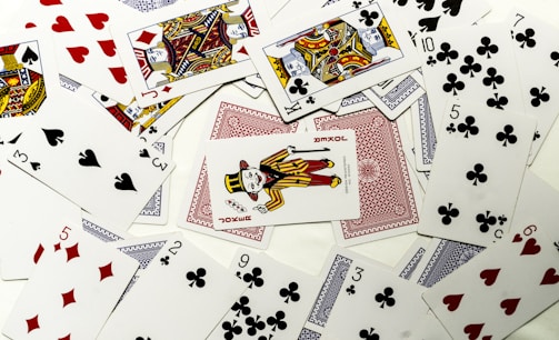 Playing cards scattered on a white surface.