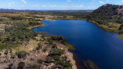A serene lake surrounded by lush, green landscape.