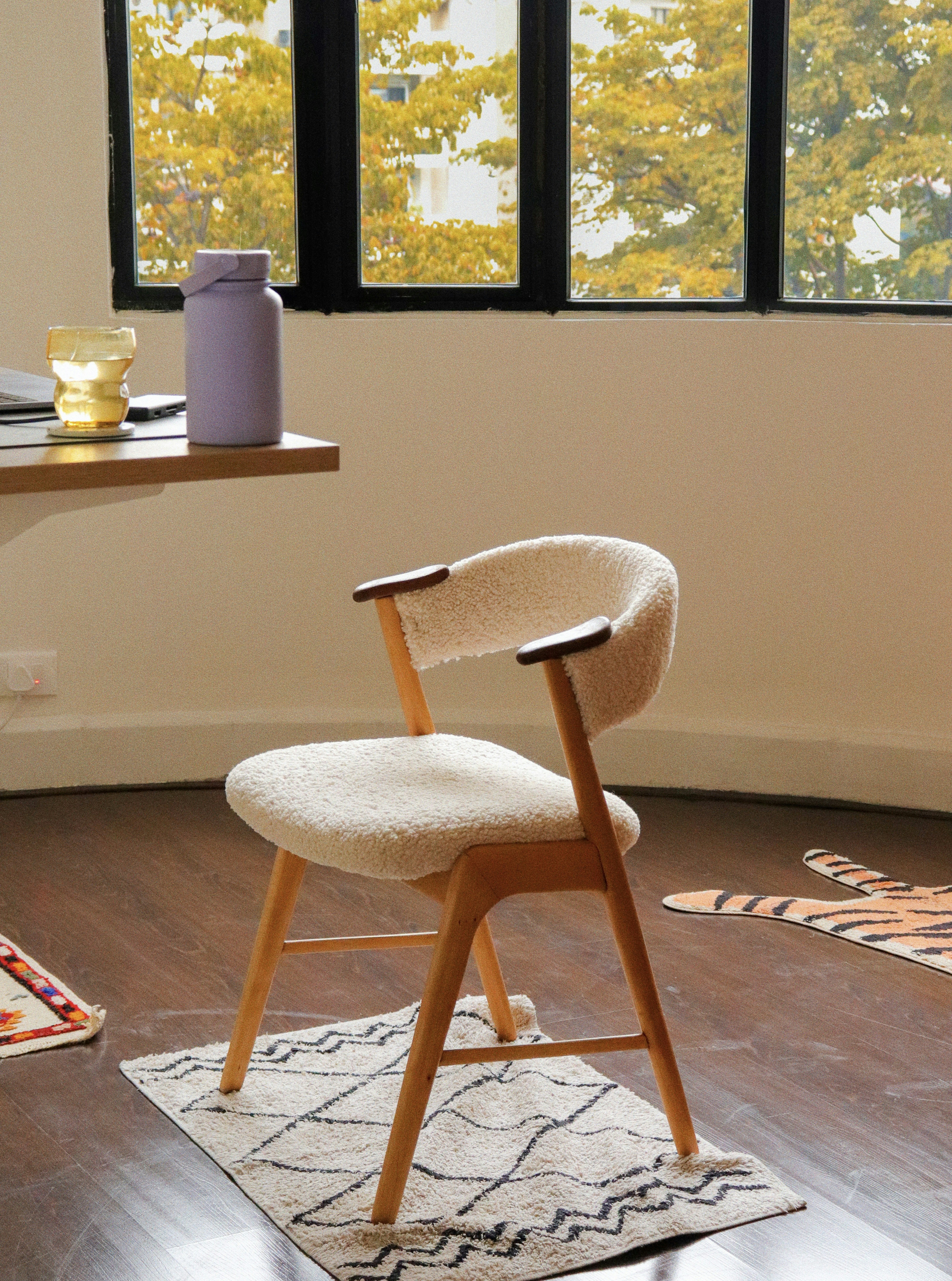 A cozy chair sits in front of a window.