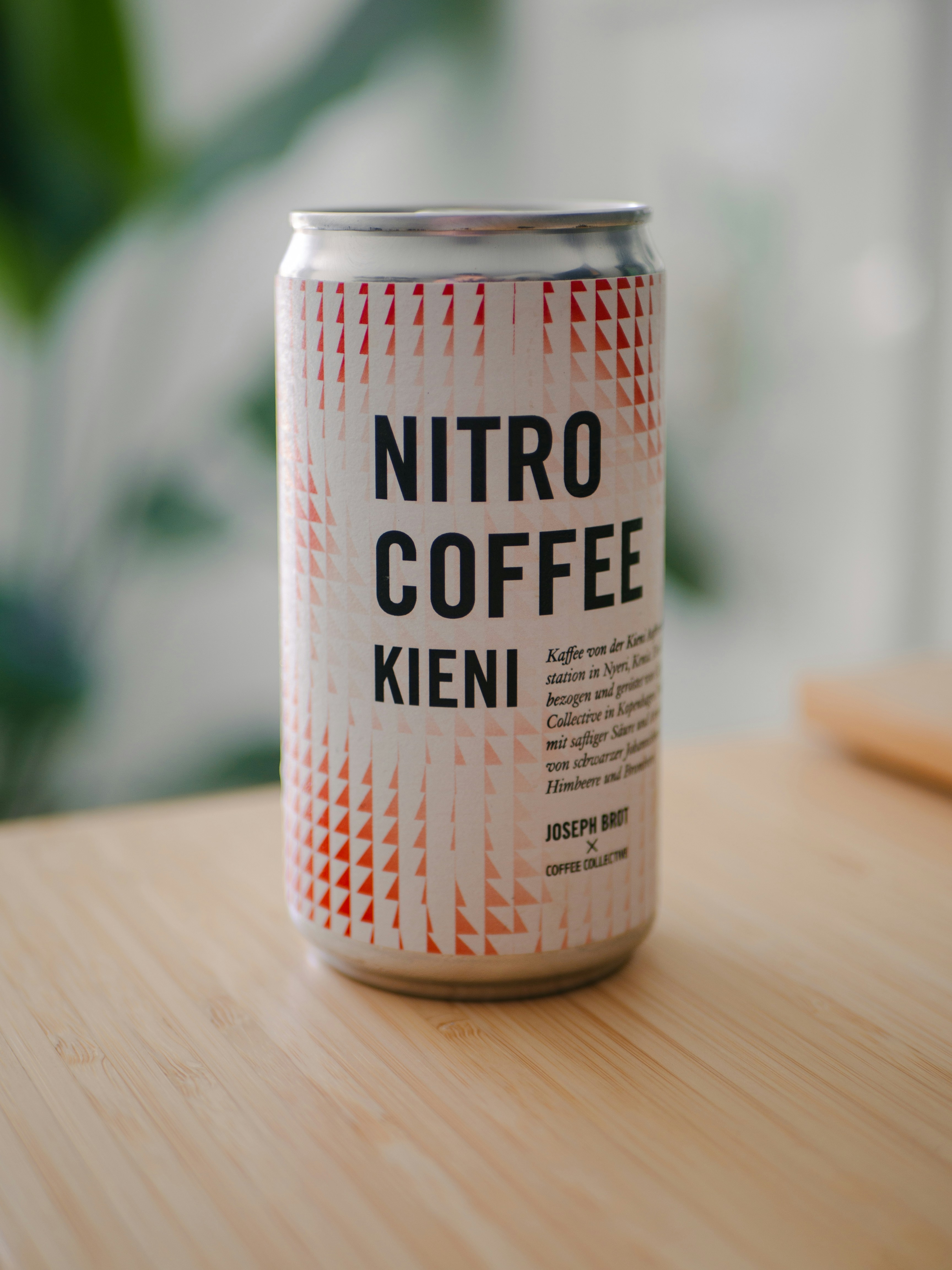Here's a single-sentence caption: nitro coffee in a can sits on a table.
