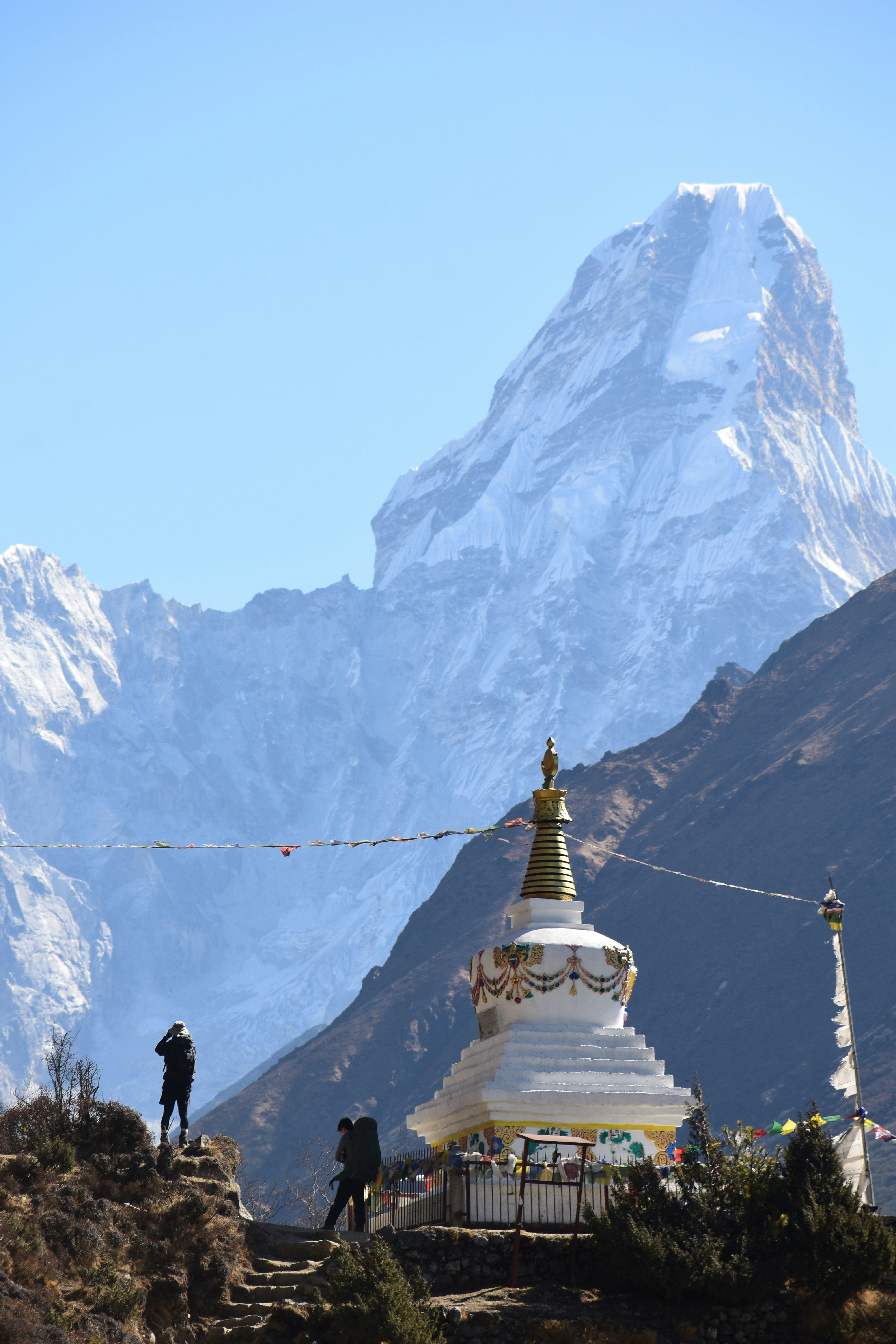 Mountain and a buddhist stupa under a clear sky.
