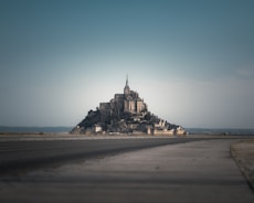 A fortress-like monastery stands dominantly in the distance.