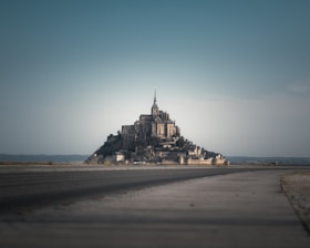 A fortress-like monastery stands dominantly in the distance.