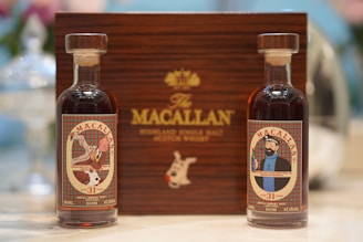 Two miniature macallan whisky bottles stand proudly.