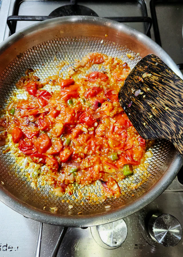 Tomatoes and spices cooking in a pan