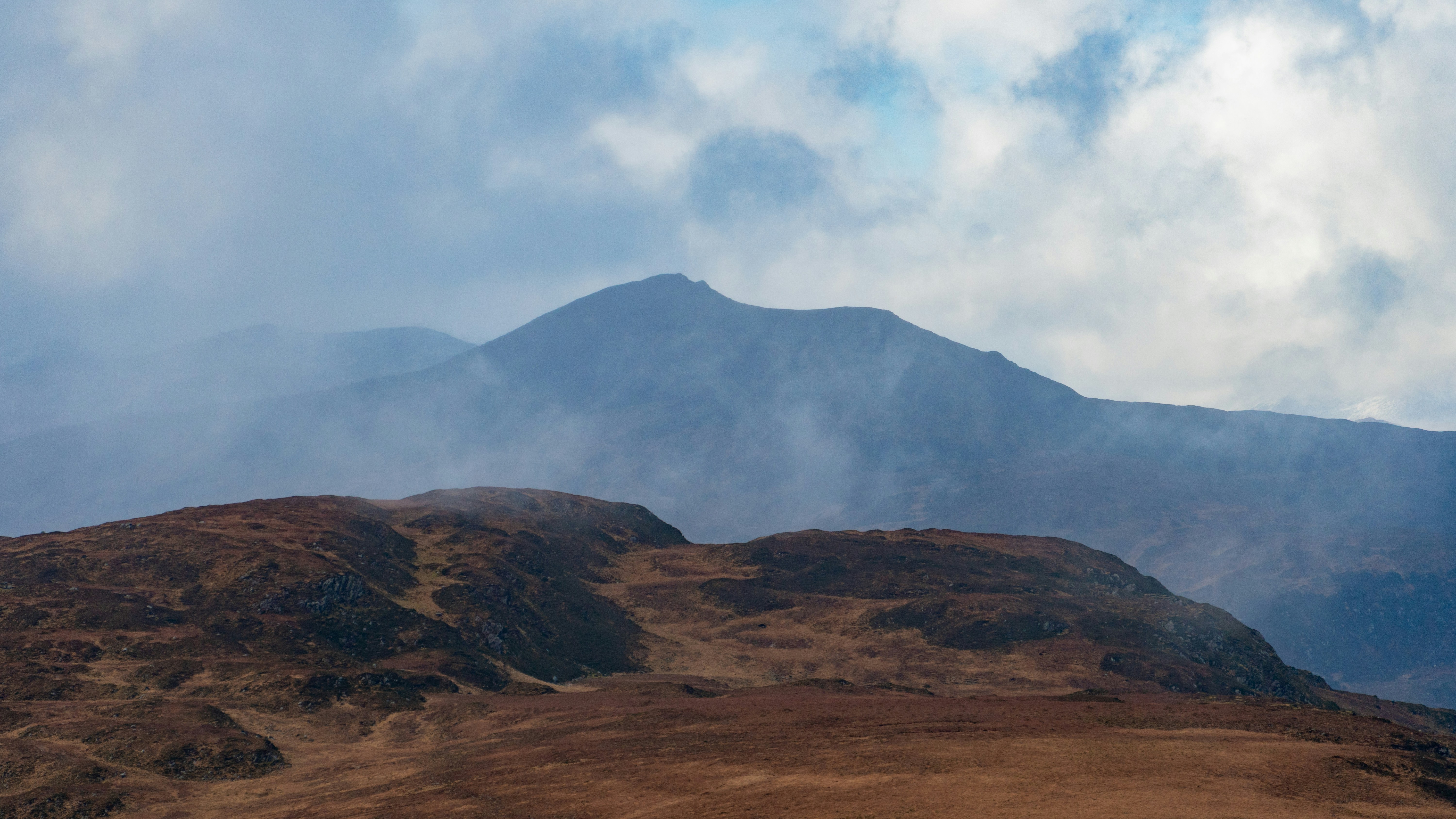 Mountains are partially obscured by clouds.