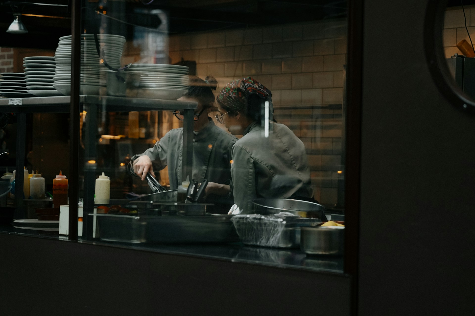 Chefs are working in a restaurant kitchen.