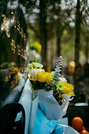 Flowers rest at a graveside memorial.