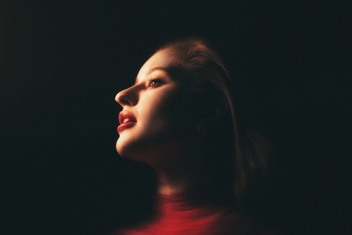 Adult woman in a softly lit warm-light side portrait