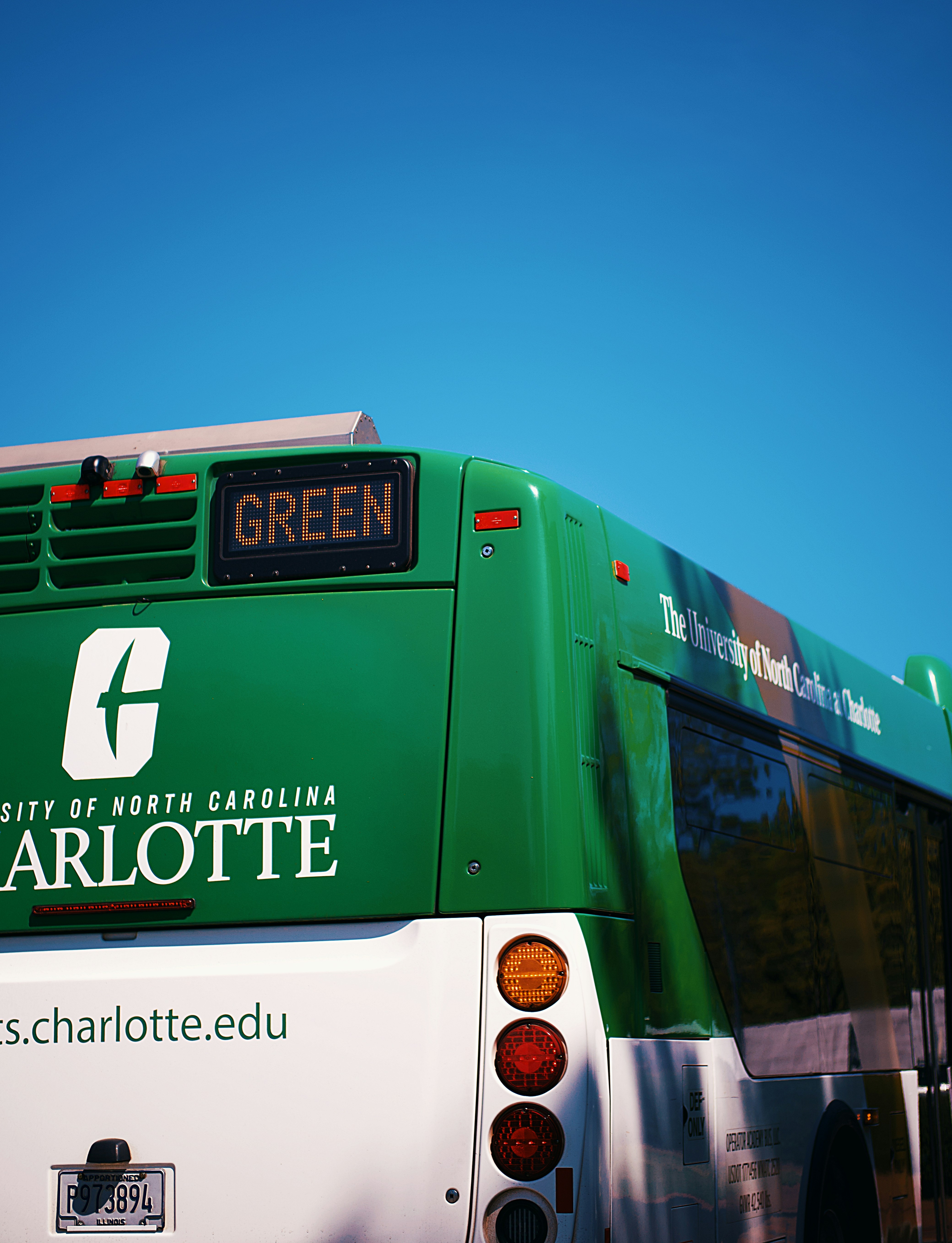 A green university of north carolina charlotte bus.