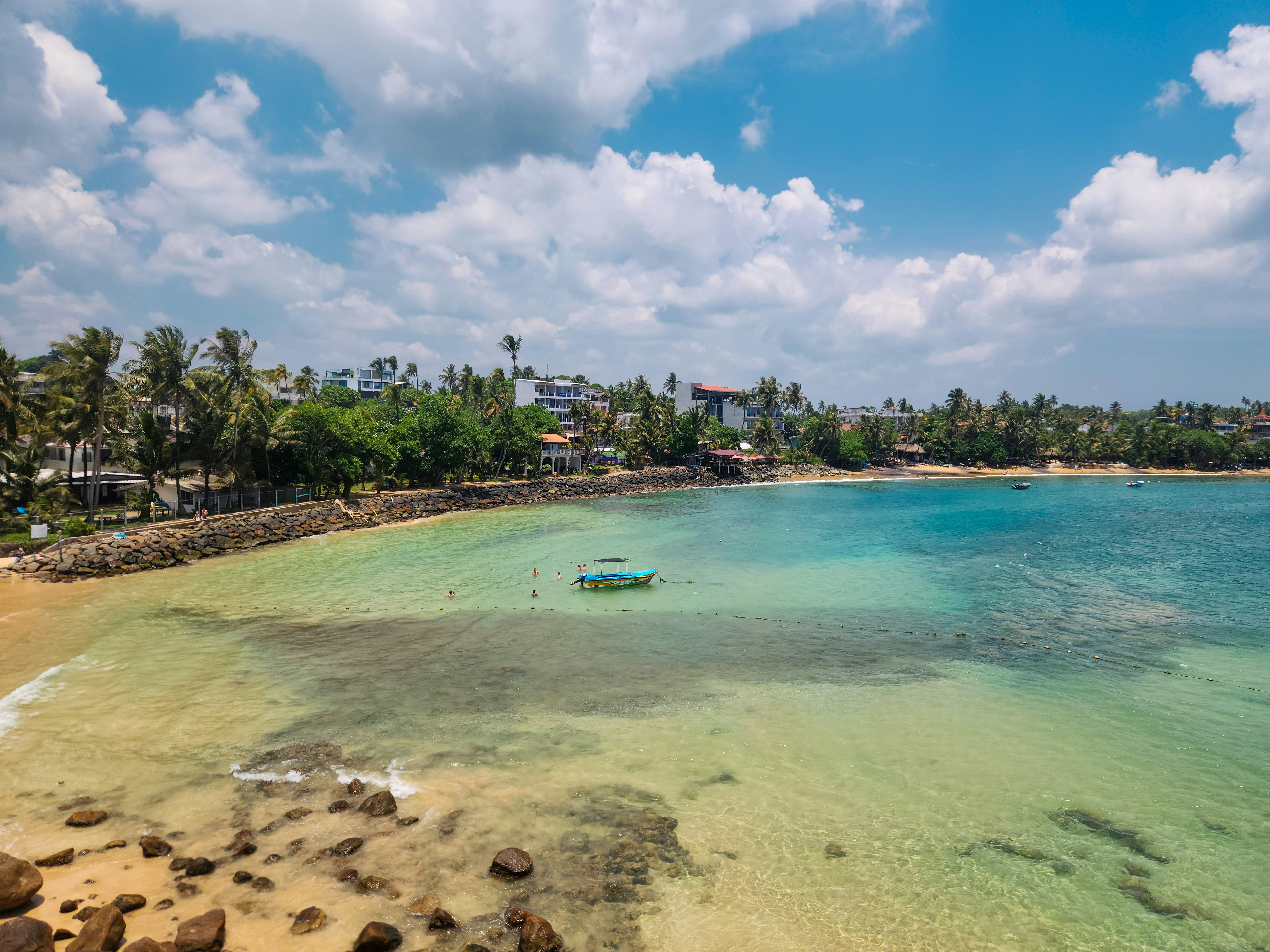 Beautiful beach with clear turquoise water under a blue sky.